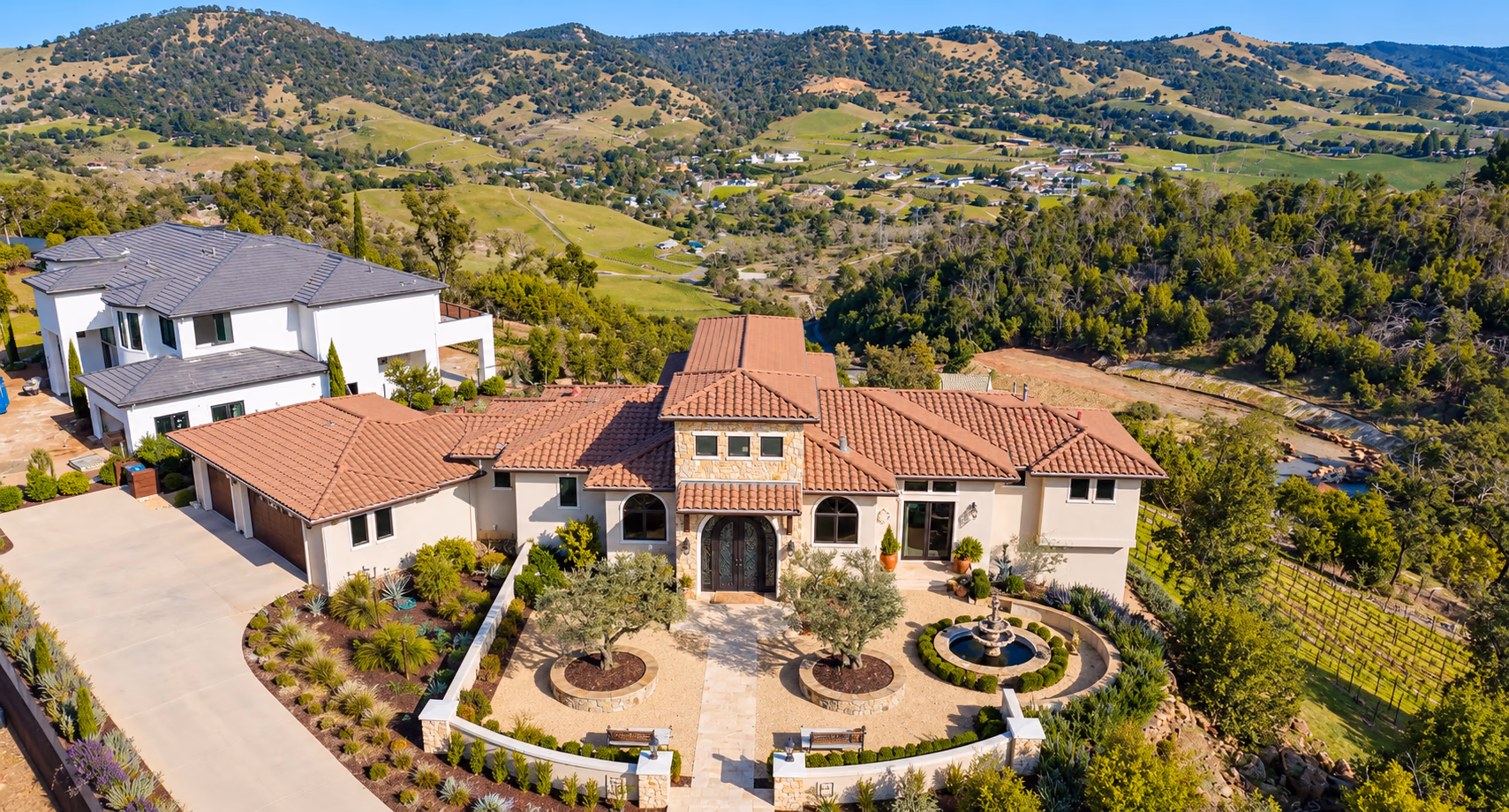 A tile-roofed home above vineyards and green hills in Santa Rosa
